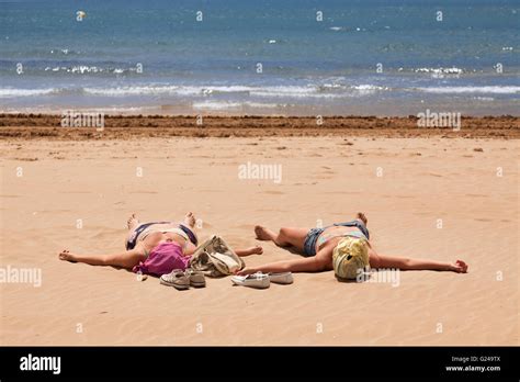 sunbathing girls|32,663 Female Sunbathing On Beach Stock Photos & High